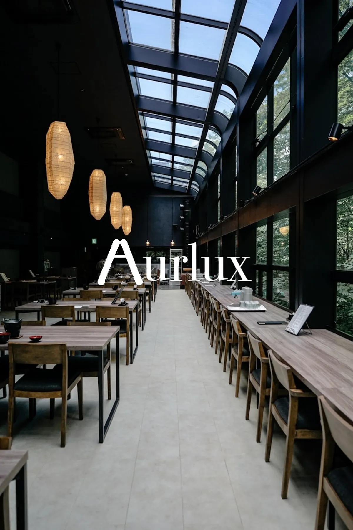 Aurlux-branded restaurant dining hall with skylight ceiling and wooden tables